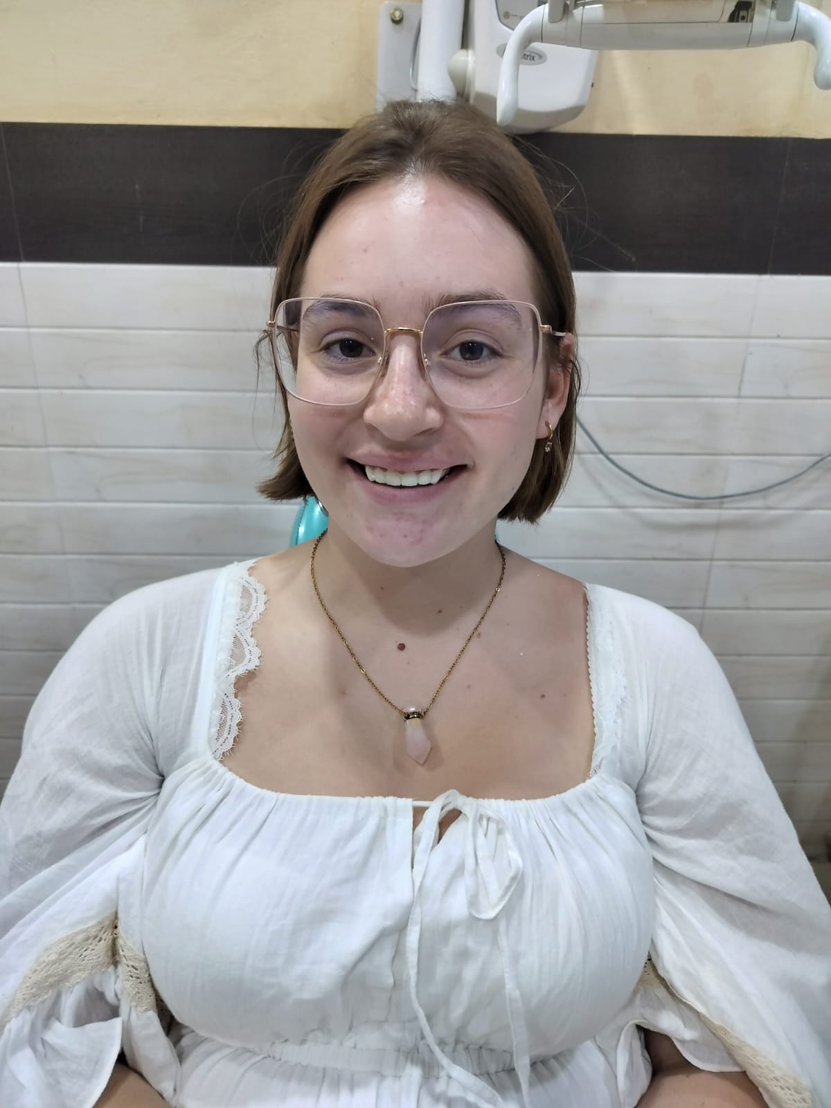 Rebeka smiling with her new teeth